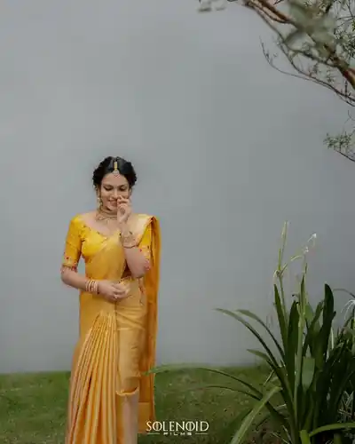 Bride in traditional gold-bordered saree